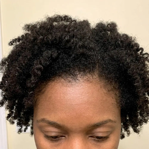 After photo of a woman showing increased hair density, a fuller part line, thicker-looking hair, and visible hair regrowth results after following a consistent hair growth routine.