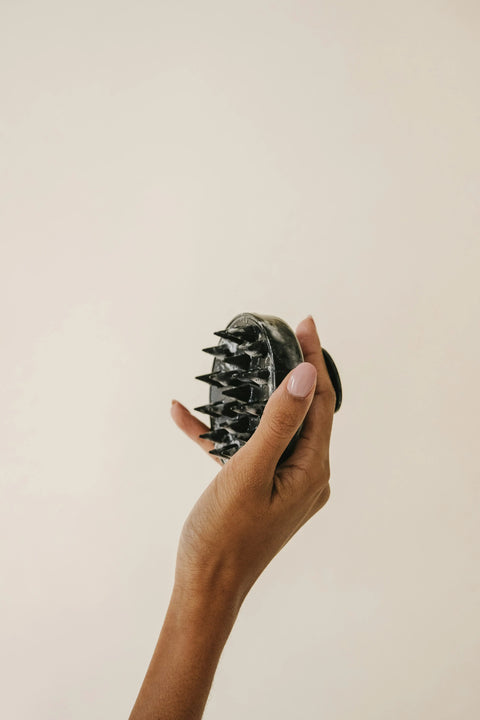 photo of a medite oils scalp scrubber to maximize hair growth naturally with a head massaging instrument