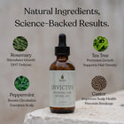 A bottle of Invictus Essential Hair Revival Oil by Medixx is displayed on a stone surface with text highlighting natural ingredients: rosemary, tea tree, peppermint, and castor.