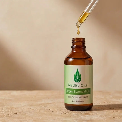 Amber dropper bottle of Medité Argan Essential Oil for hair growth and scalp care, plant-based therapeutic grade formula