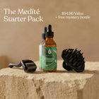 Medité hair growth starter kit with Essential Rosemary Hair Revival Oil, dermaroller, and scalp scrubber on a natural stone display