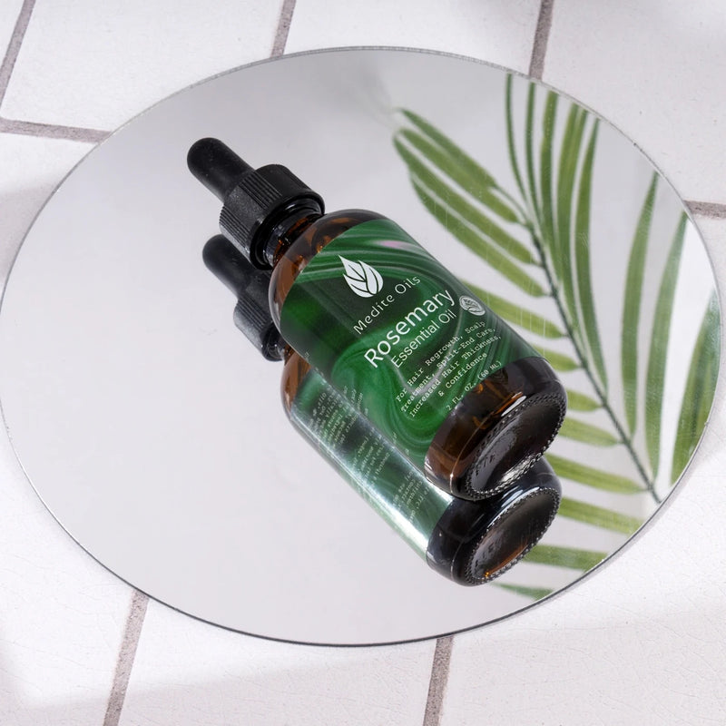 Medíté rosemary hair growth oil with mirror reflection for scalp treatment thinning hair support and healthier thicker fuller looking hair